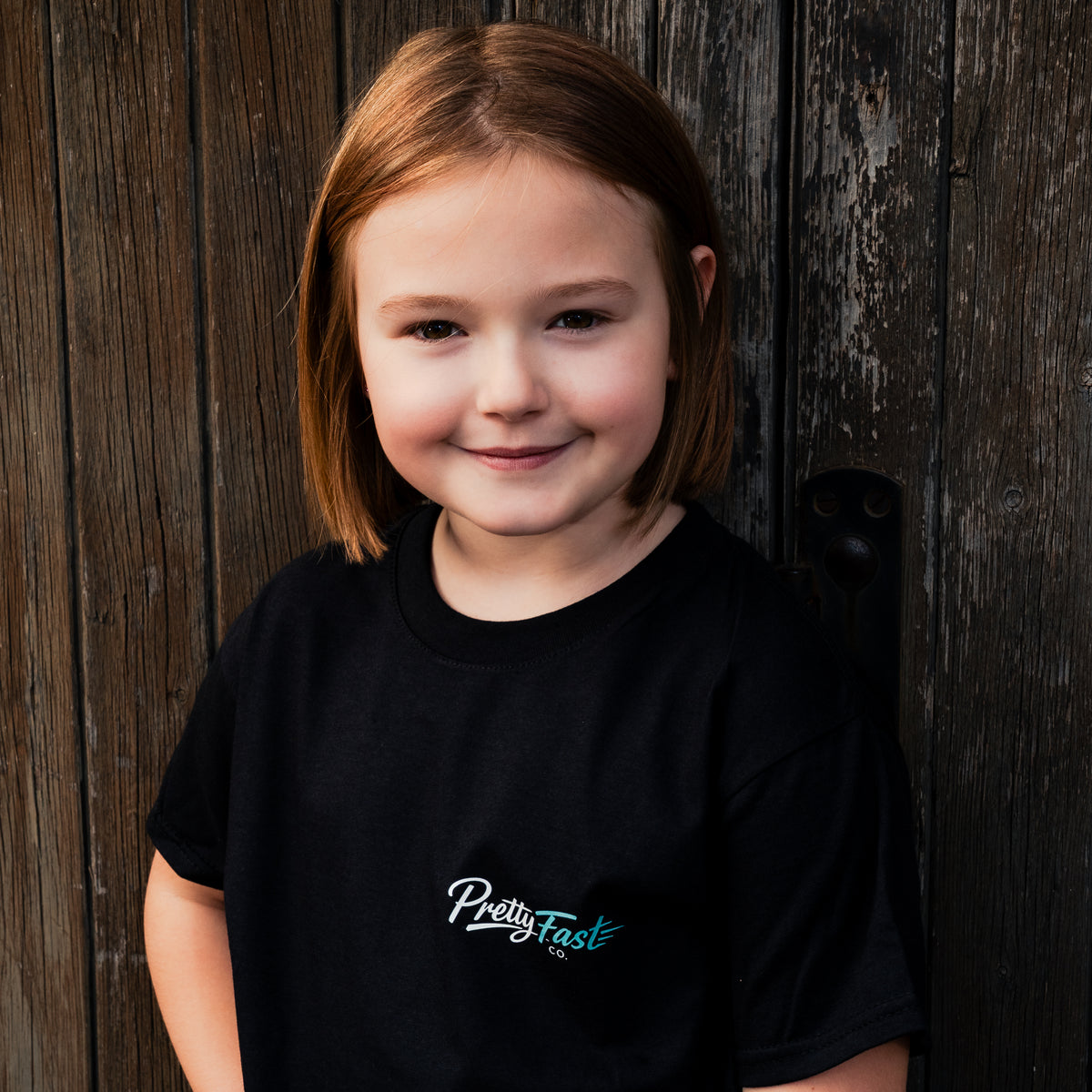 PrettyFastCo Kids Original Tee In Black With Turquoise Logo